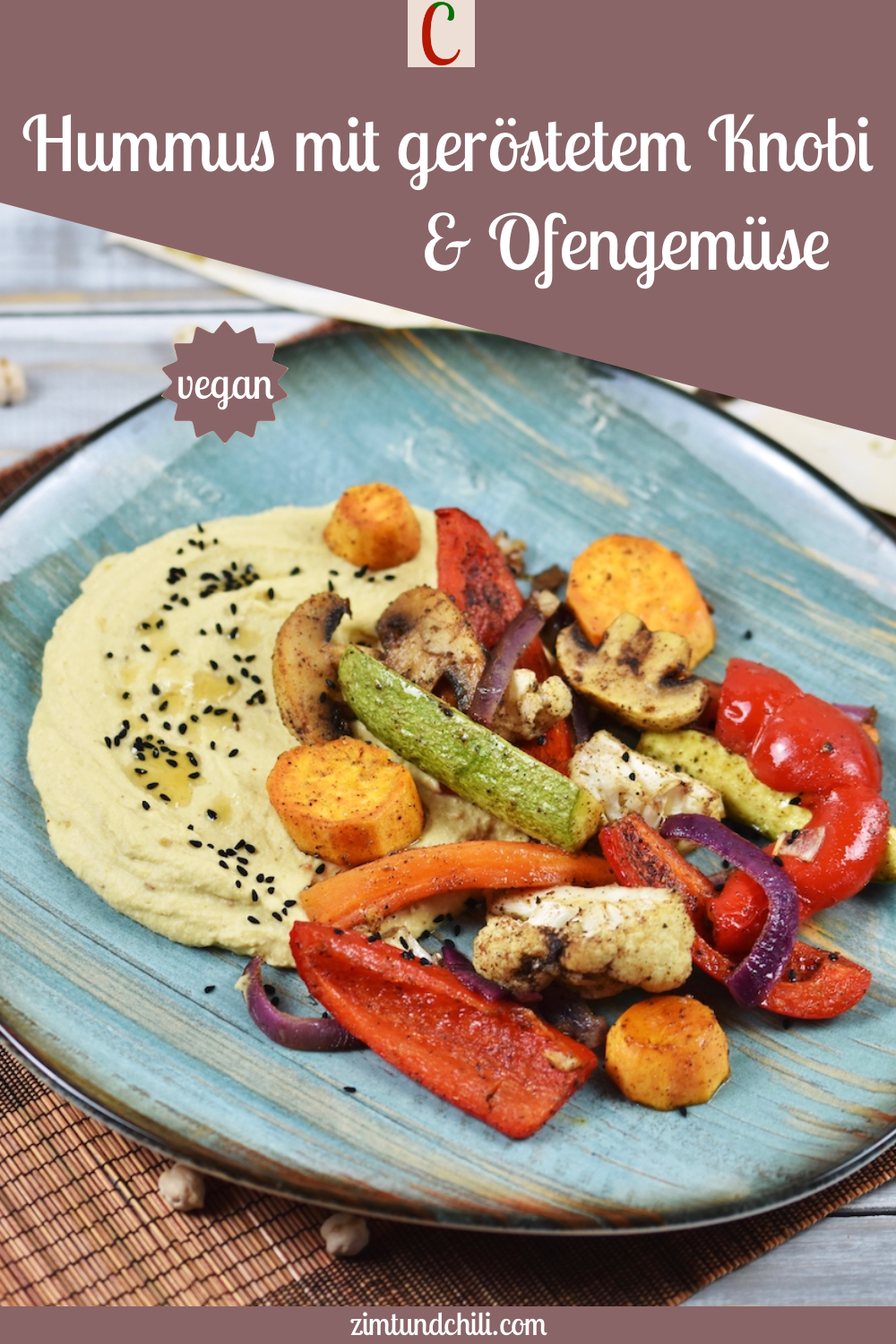 Hummus mit geröstetem Knoblauch und Ofengemüse auf türkisem Teller.