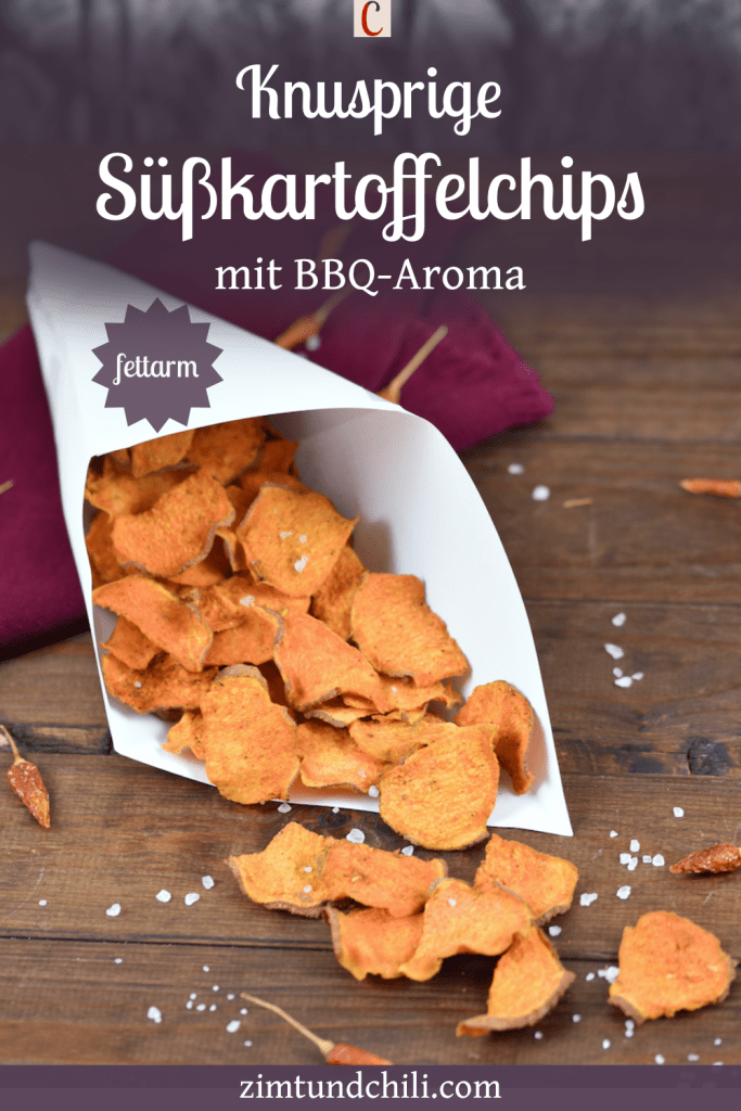 Knusprige Süßkartoffelchips mit BBQ-Aroma in einer Papiertüte. Hintergrund dunkel. Beschrifteter Pin.