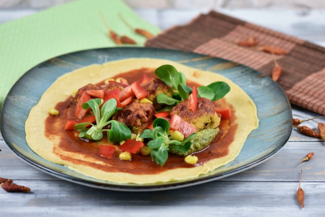 Vegane Burritos mit knusprigen Blumenkohlwings belegt aber noch nicht aufgerollt.