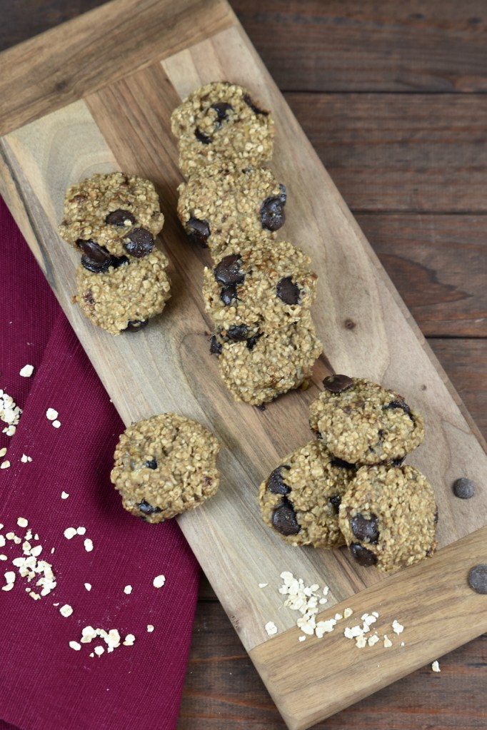 Weiche Chocolate Chip Cookies auf Holzbrett. Hintergrund dunkel.